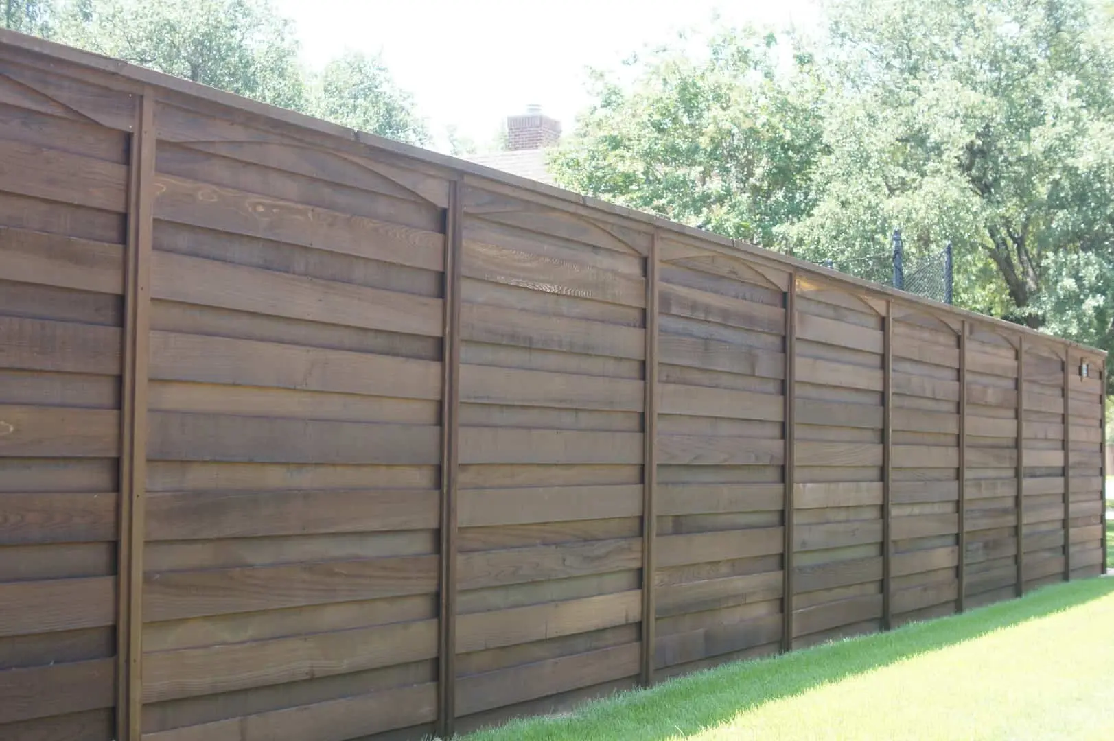Professional Fence Installation Company dark stained wood privacy fence